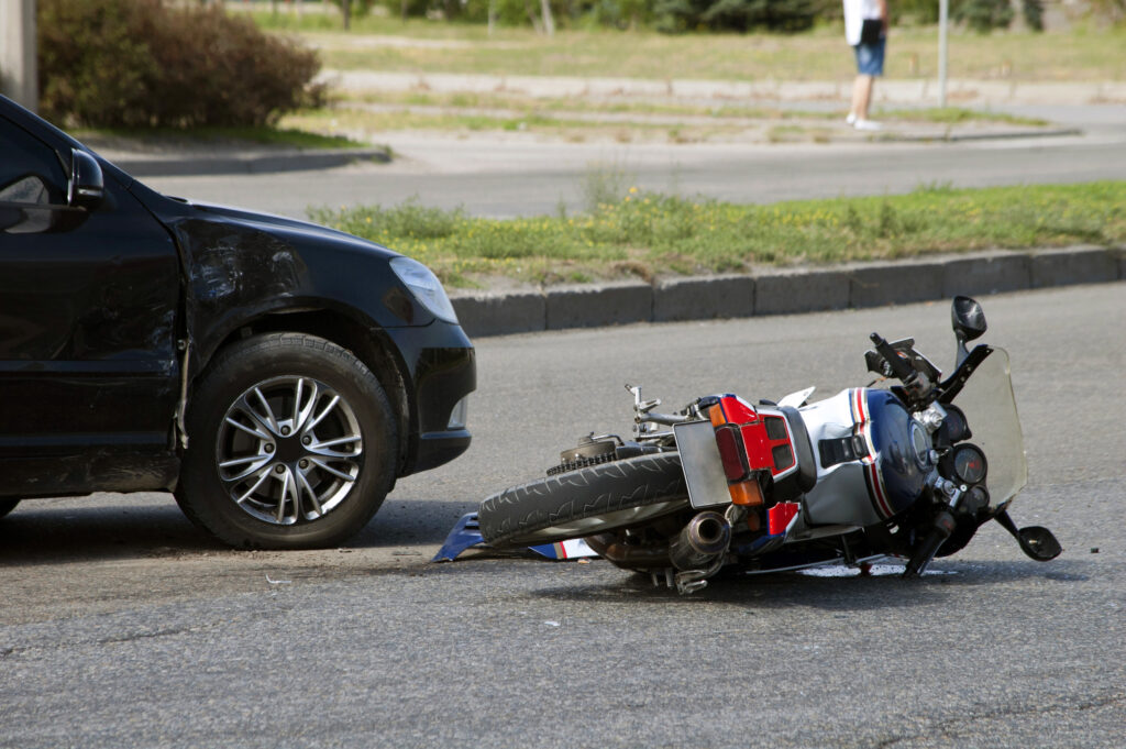 car and downed motorcycle after an accident
