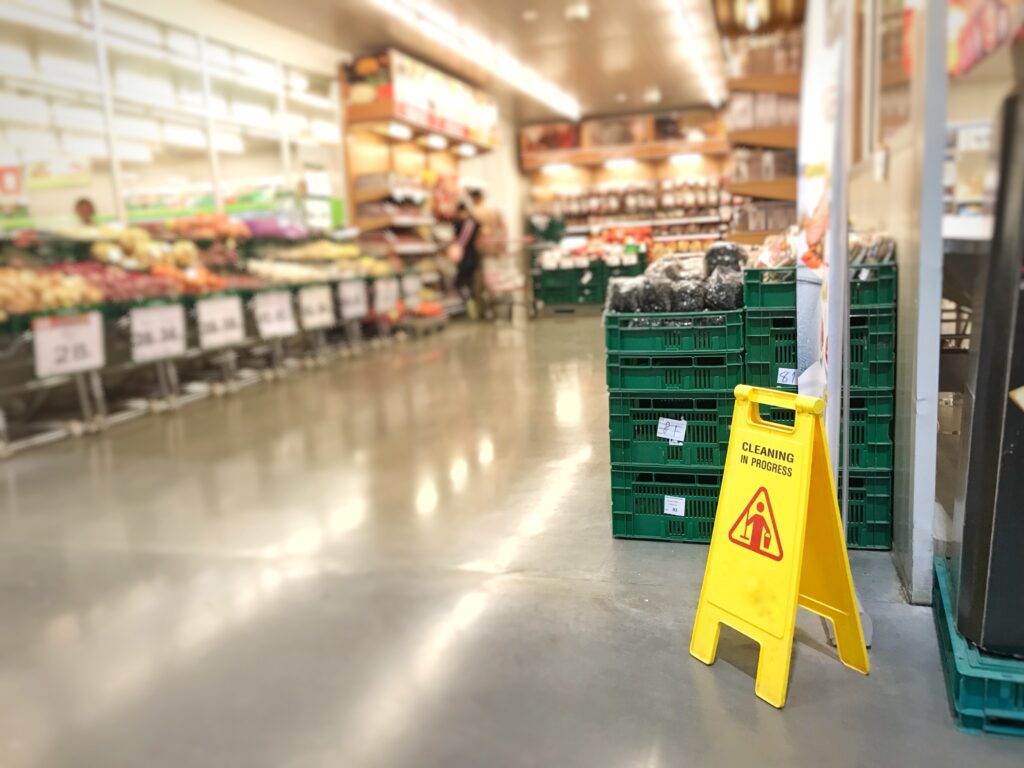 a supermarket with a wet floor sign 