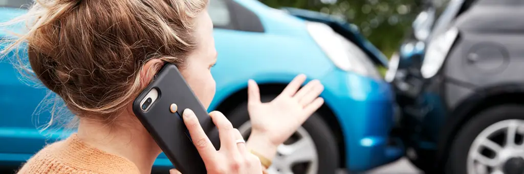 Female Motorist Involved In Car Accident Calling Insurance Company Or Recovery Service