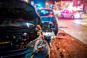 Two cars involved in an accident with a police car in the background in El Paso.