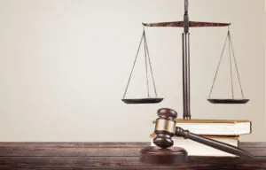 A gavel, books, and a statue on a wooden table in El Paso.